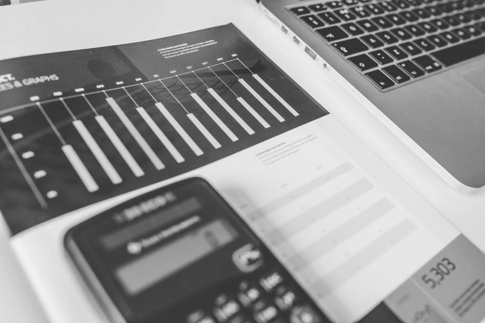 Microsoft Fabric vs Power BI - financial documents and calculator on a desk